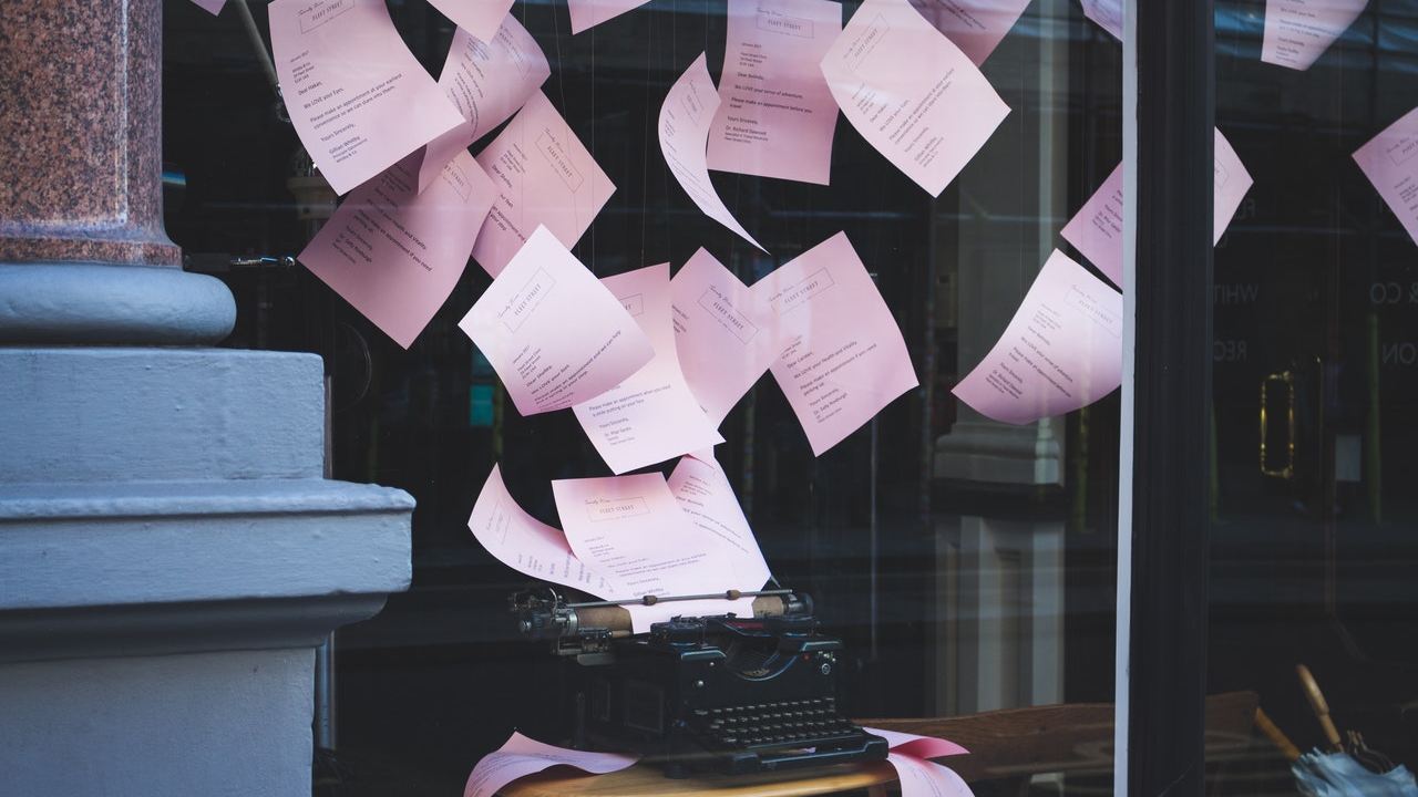 typewriter with papers flying everywhere representing content without purpose