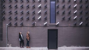 a wall of security cameras signifying data privacy and marketing