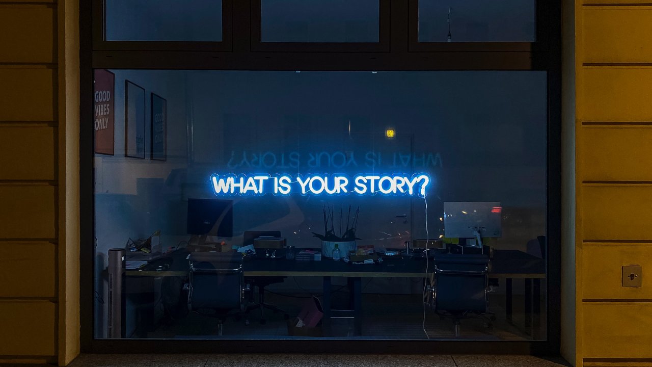 neon sign that says what is your story?